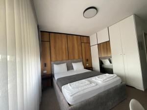 A bed or beds in a room at New Prishtina Luxury Rooms