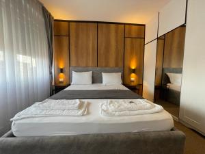 A bed or beds in a room at New Prishtina Luxury Rooms