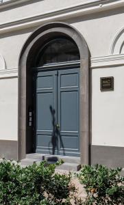 a blue door on the side of a building at K40 Romantic Deluxe Studio In the City Center in Budapest