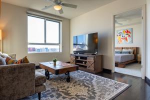 a living room with a couch and a tv at Luxury Apartment West Hollywood in Los Angeles