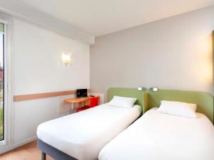 Tempat tidur dalam kamar di ibis Budget Mâcon Sud