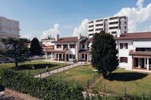 a group of houses with a park in front of them at Anima Jesolo - Ca' delle Rose in Lido di Jesolo