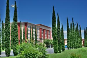 a row of trees in front of a building at Lux Hotel & Spa, Trademark Collection by Wyndham in Arlington