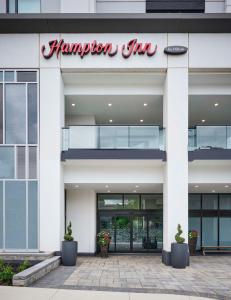 a hampton inn sign on the front of a building at Hampton Inn By Hilton Hamilton in Hamilton