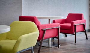 two chairs and a table in a room at Hampton Inn By Hilton Hamilton in Hamilton