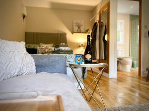 a living room with a bottle of wine on a table at Highland HotTub Retreat, on NC500 in Inverness