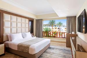 a hotel room with a bed and a balcony at Pickalbatros Royal Grand Sharm - Adults Friendly 16 Years Plus in Sharm El Sheikh