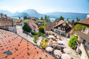 une vue aérienne sur une ville avec des bâtiments et des parasols dans l'établissement Cabana & Au Coeur du Village, à Talloires