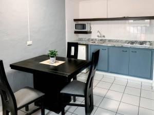 une cuisine avec une table noire et deux chaises dans l'établissement La Casa del Expositor, à Guadalajara