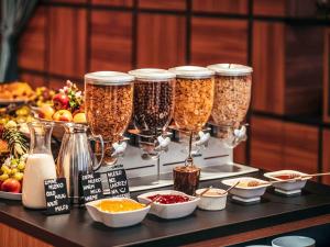 a buffet of food with four jars of food at ibis Styles Wałbrzych in Wałbrzych