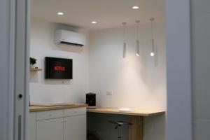 a kitchen with a desk with a clock on the wall at Maison Nona in Torre del Greco