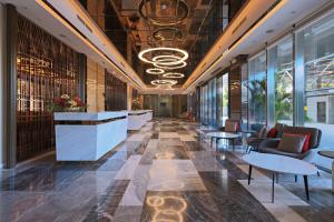 a lobby with couches and tables in a building at Best Western Plus Metro Clark in Angeles