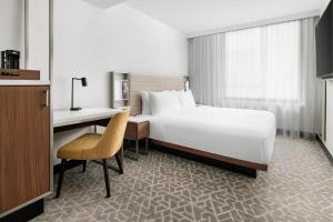 A bed or beds in a room at SpringHill Suites by Marriott New York Manhattan/Times Square South