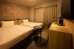 Кровать или кровати в номере Shizutetsu Hotel Prezio Osaka Shinsaibashi