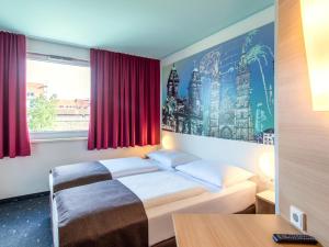 a hotel room with a bed and a window at B&B Hotel Nürnberg-City in Nürnberg