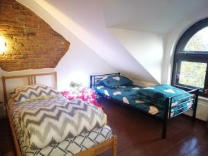 a bedroom with two beds in a attic at Ewa Dom in Warsaw