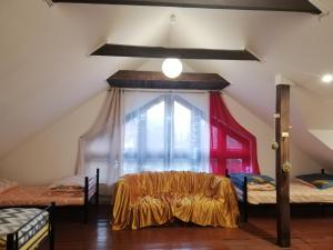 a attic room with two beds and a window at Ewa Dom in Warsaw