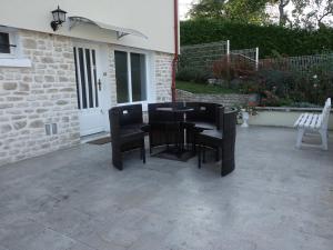 a black table and chairs on a patio at LES GRADINES in Bar-sur-Aube