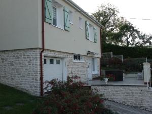 a brick house with a white door and windows at LES GRADINES in Bar-sur-Aube