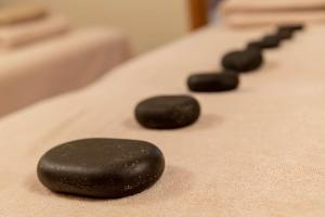 a row of black rocks sitting on a table at Country Inn & Suites By Radisson Navi Mumbai in Navi Mumbai