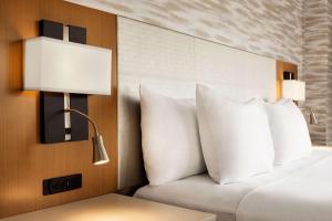 A bed or beds in a room at Park Plaza Chandigarh Zirakpur