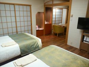 Posteľ alebo postele v izbe v ubytovaní JR Hotel Clement Tokushima