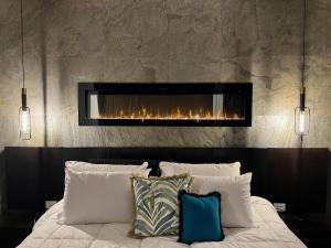 a bedroom with a bed with a fireplace at On Eagle Wings Mountain Retreat & Spa in Neranwood