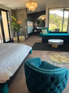 a bedroom with a bed and a couch and a table at On Eagle Wings Mountain Retreat & Spa in Neranwood