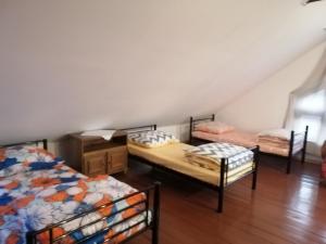 a room with three beds in a attic at Ewa Dom in Warsaw