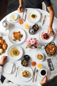 a white table with plates of food on it at The Peninsula Paris in Paris