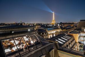 a view of a city with the eiffel tower at The Peninsula Paris in Paris