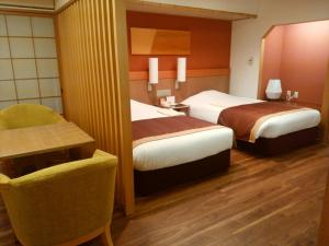 Posteľ alebo postele v izbe v ubytovaní JR Hotel Clement Tokushima