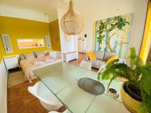 a living room with a glass table and a couch at The Beachhouse Apartments in Vaia