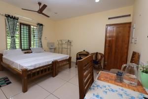 Krevet ili kreveti u jedinici u objektu GREENVIEW HOMESTAY KOVALAM