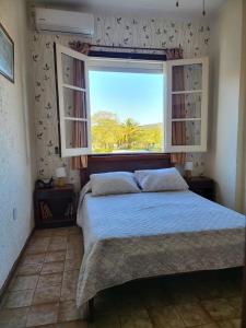 A bed or beds in a room at Apartamento con Terraza y Parrillero