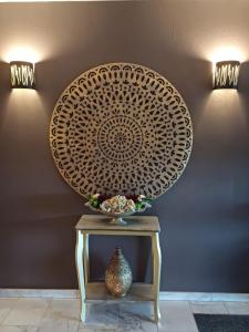 a table with a vase on it next to a wall at Park Hotel Airport in Charleroi