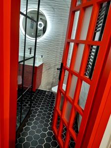 a red door leading to a bathroom with a toilet at fruit tower 300Mbps in Thessaloniki