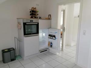 a kitchen with a refrigerator with a tv in it at Ferienwohnung Grete in Trier