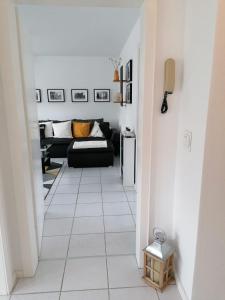 a living room with a couch and a tiled floor at Ferienwohnung Grete in Trier