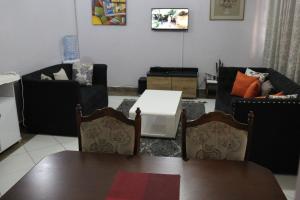 sala de estar con sofás, mesa y sillas en AVISHAI HOMES, en Kisumu