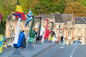 a row of colorful flags on the side of a road at ibis Dinant Centre in Dinant