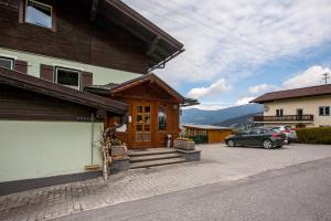 ein Haus mit einem Auto auf einem Parkplatz in der Unterkunft Gästehaus Zum Tauern in Radstadt