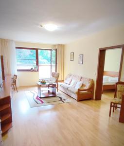 a living room with a couch and a table at Hotel Ambra in Luhačovice