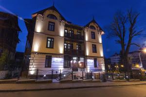 a large building with lights on it at night at Villa Mozart in Truskavets