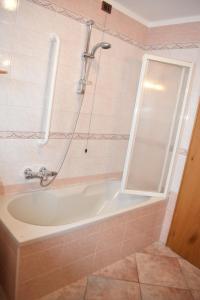 a bathroom with a bath tub and a window at Appartamento Trela 2 in Livigno