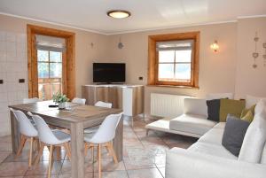 a living room with a table and a couch at Appartamento Trela 2 in Livigno