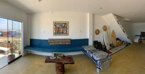 a living room with a couch and a table at Tayta Surf House in Lobitos