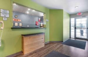 een wachtkamer met groene muren en een houten aanrecht bij Extended Stay America Select Suites - Fayetteville - I-49 in Fayetteville