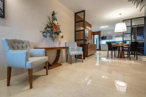 a living room with chairs and a dining room at Apartment on the Main Street with Parking Old Town in Košice