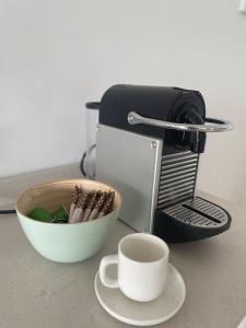 a coffee maker and a cup of coffee on a counter at Can Estrellas, appartement d'exception sur la mer in Roses